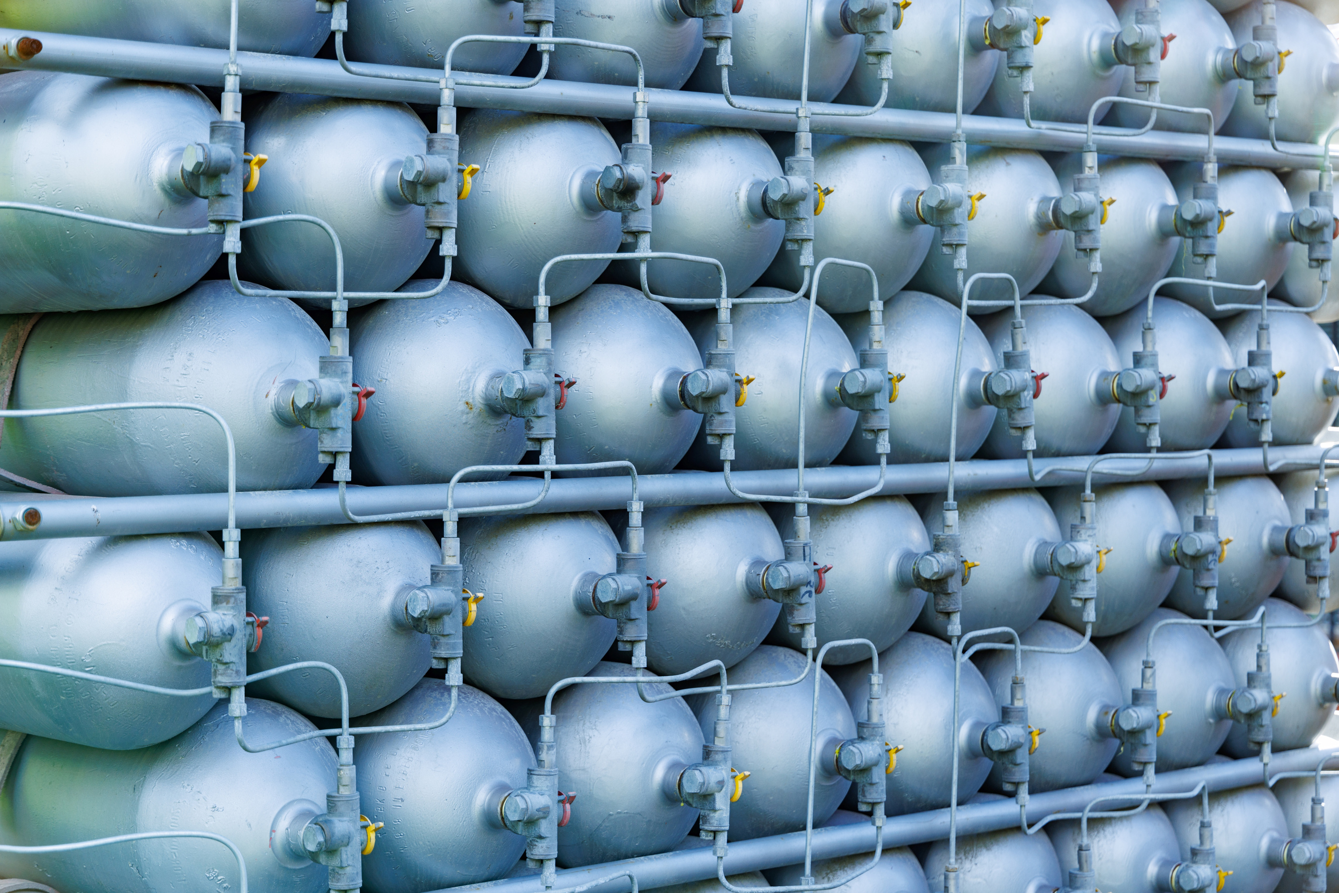 A Lot of Bottles Filled with Gas or Gasoline Are Stacked in Piles