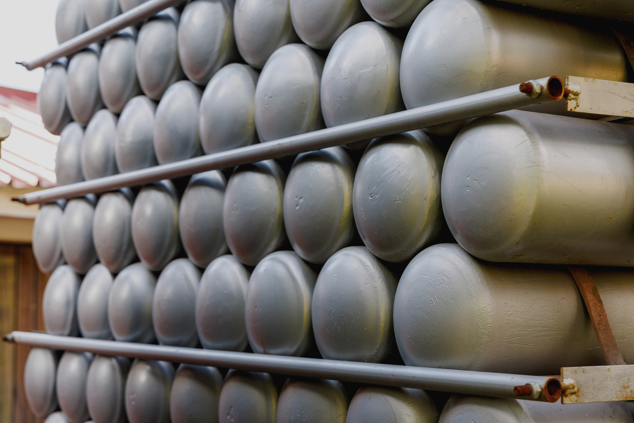 A Lot of Bottles Filled with Gas or Gasoline Are Stacked in Piles