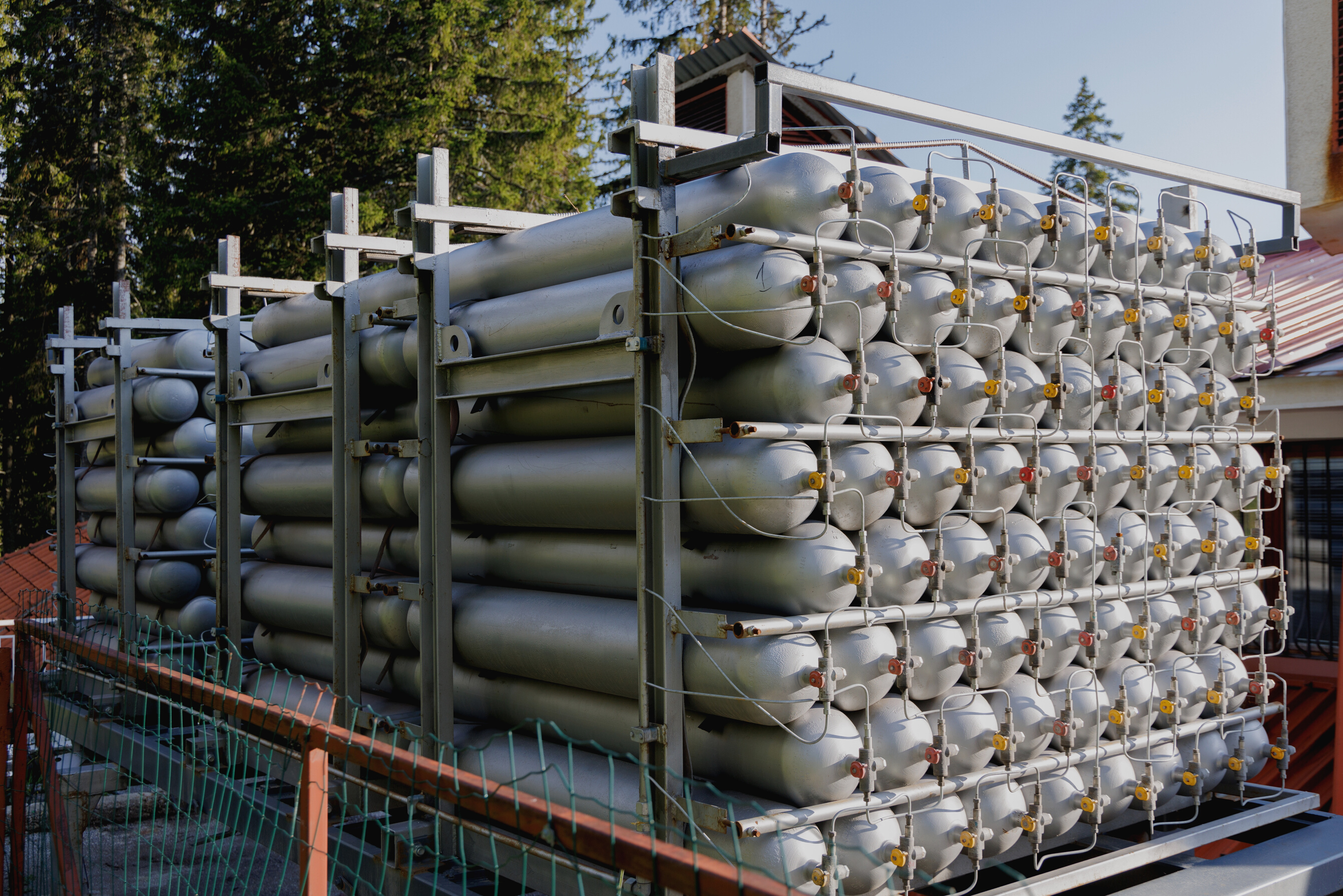 A Lot of Bottles Filled with Gas or Gasoline Are Stacked in Piles