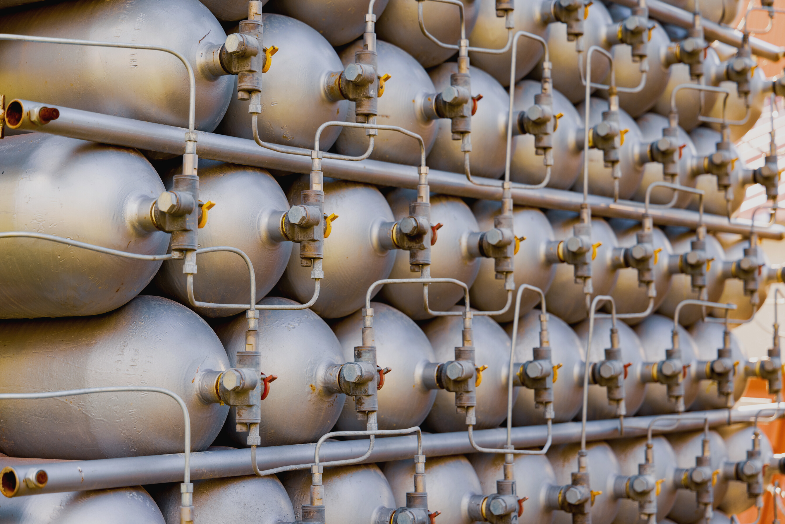 A Lot of Bottles Filled with Gas or Gasoline Are Stacked in Piles