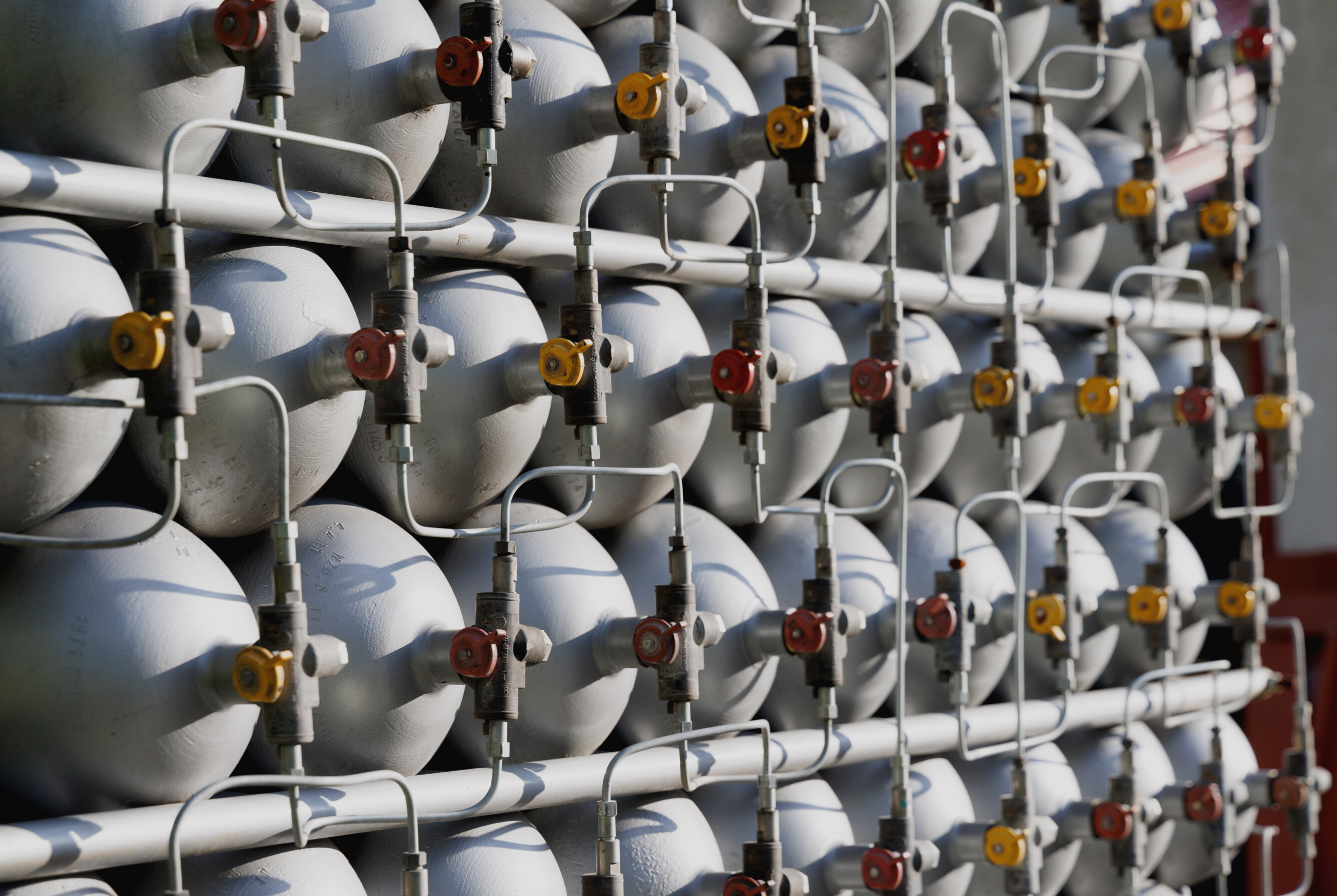 A Lot of Bottles Filled with Gas or Gasoline Are Stacked in Piles