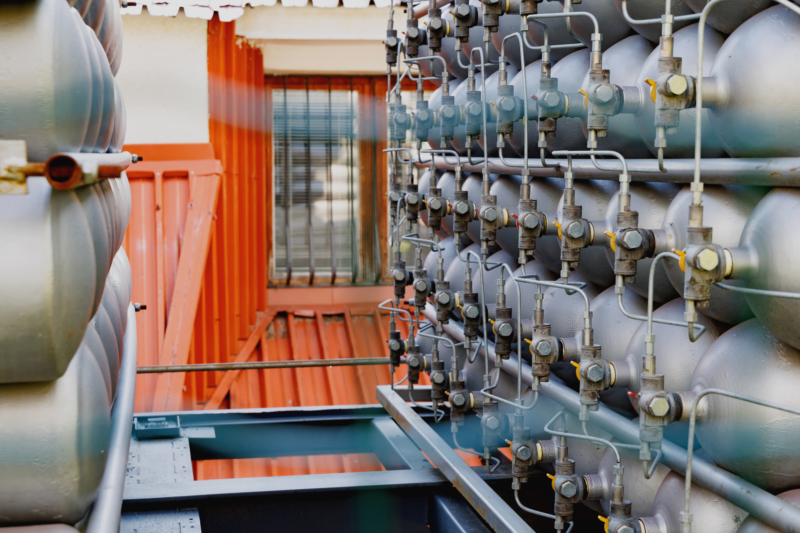 A Lot of Bottles Filled with Gas or Gasoline Are Stacked in Piles