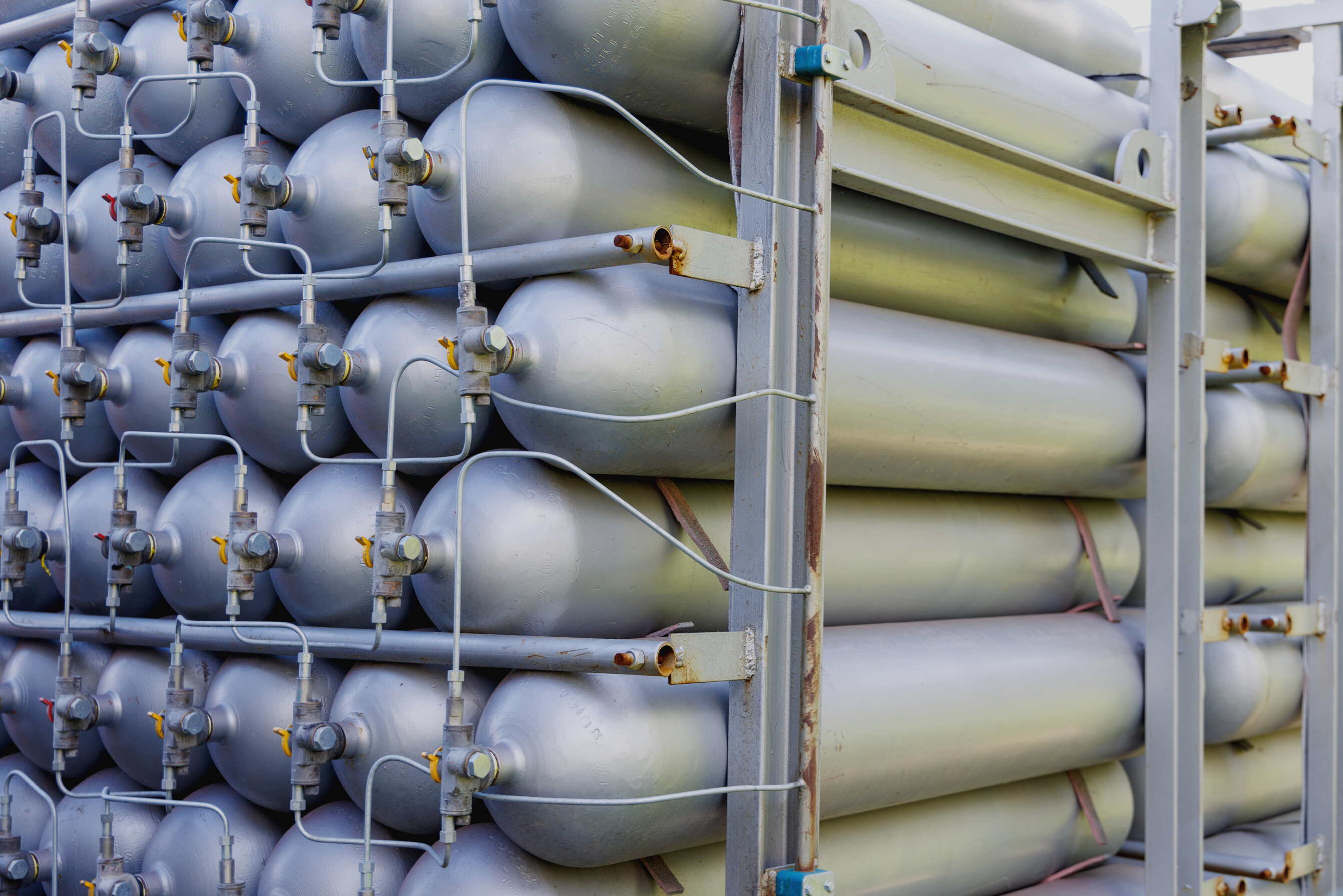 A Lot of Bottles Filled with Gas or Gasoline Are Stacked in Piles