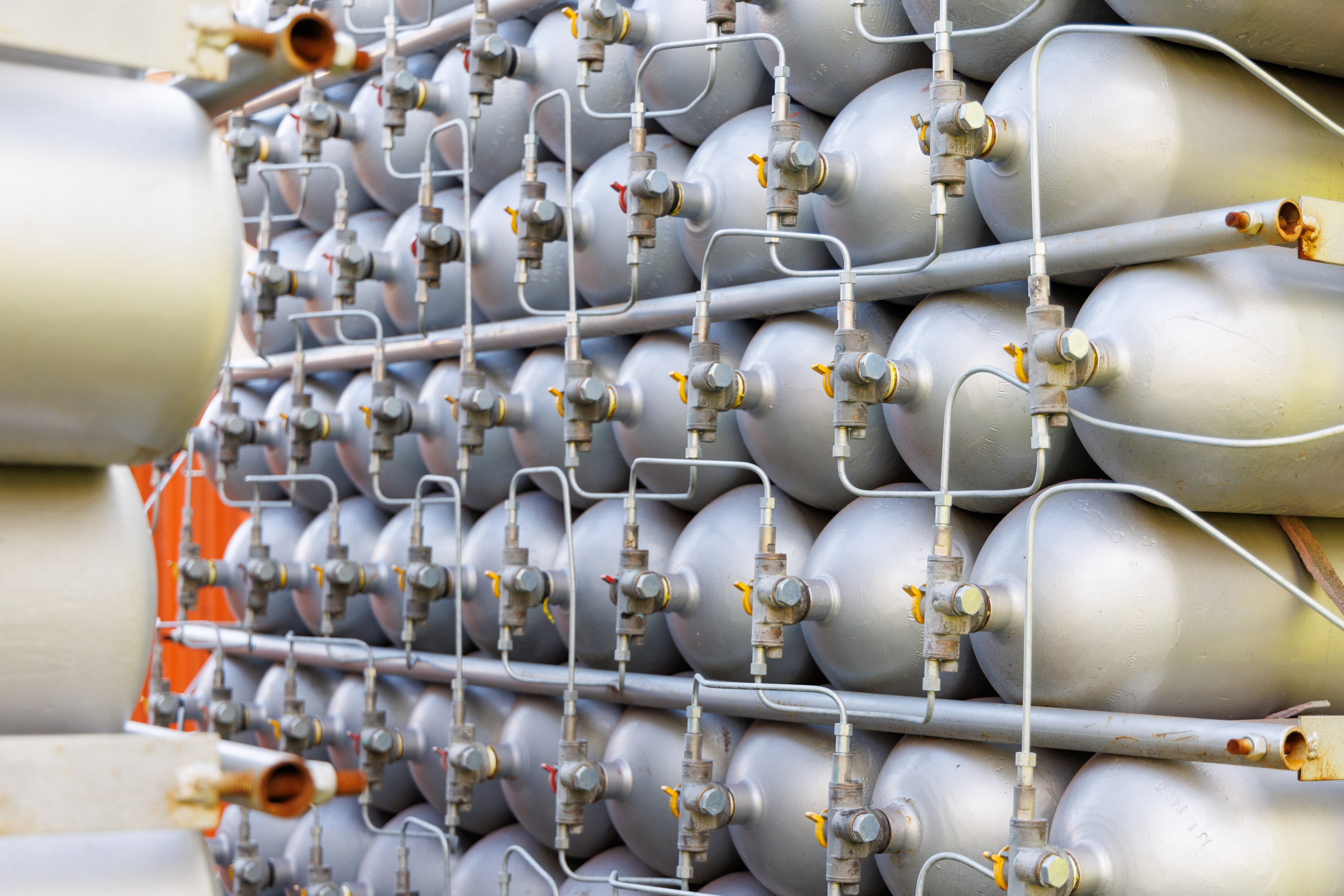 A Lot of Bottles Filled with Gas or Gasoline Are Stacked in Piles