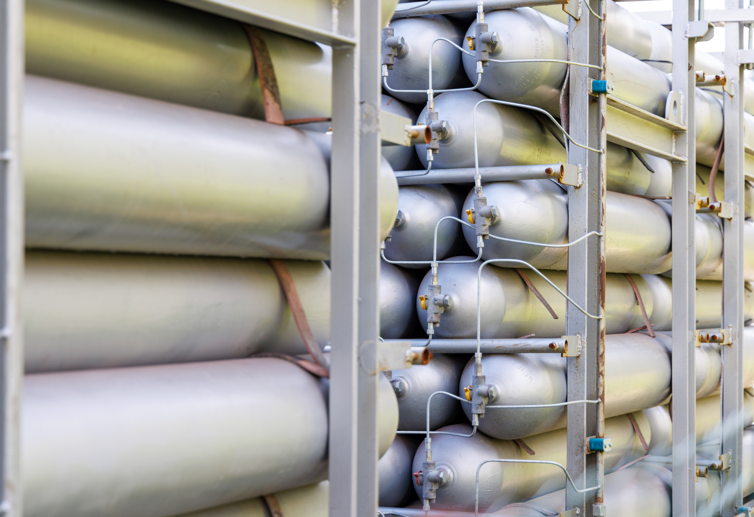 A Lot of Bottles Filled with Gas or Gasoline Are Stacked in Piles